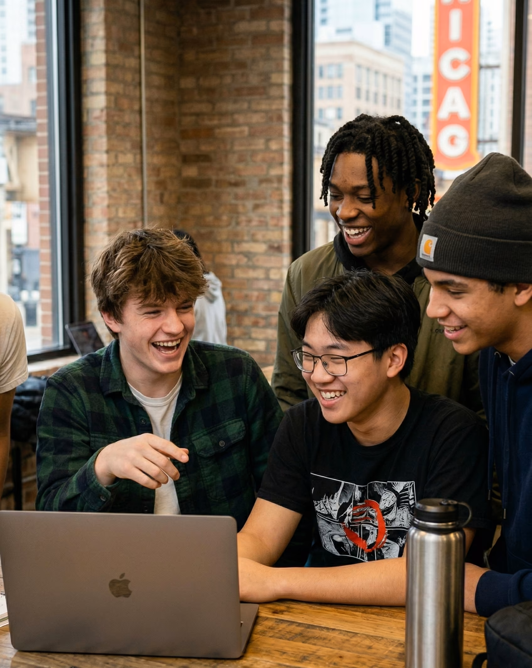 Friends collaborating on laptop